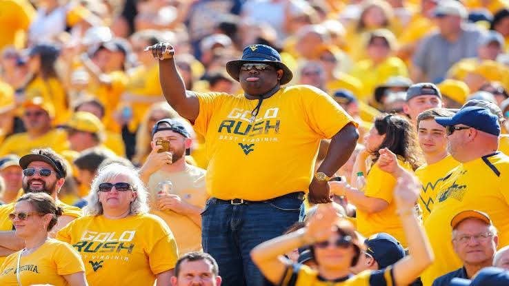 A storm of joy sweeps through Morgantown The nation bows to Mountaineer passion West Virginia fans crowned the best of them all No crowd louder, no hearts prouder From football fields to basketball courts – unity reigns Blue and gold fire lights every game day sky A tradition of pride now recognized worldwide The spirit of WVU stands unmatched College sports has found its heartbeat And it beats in West Virginia